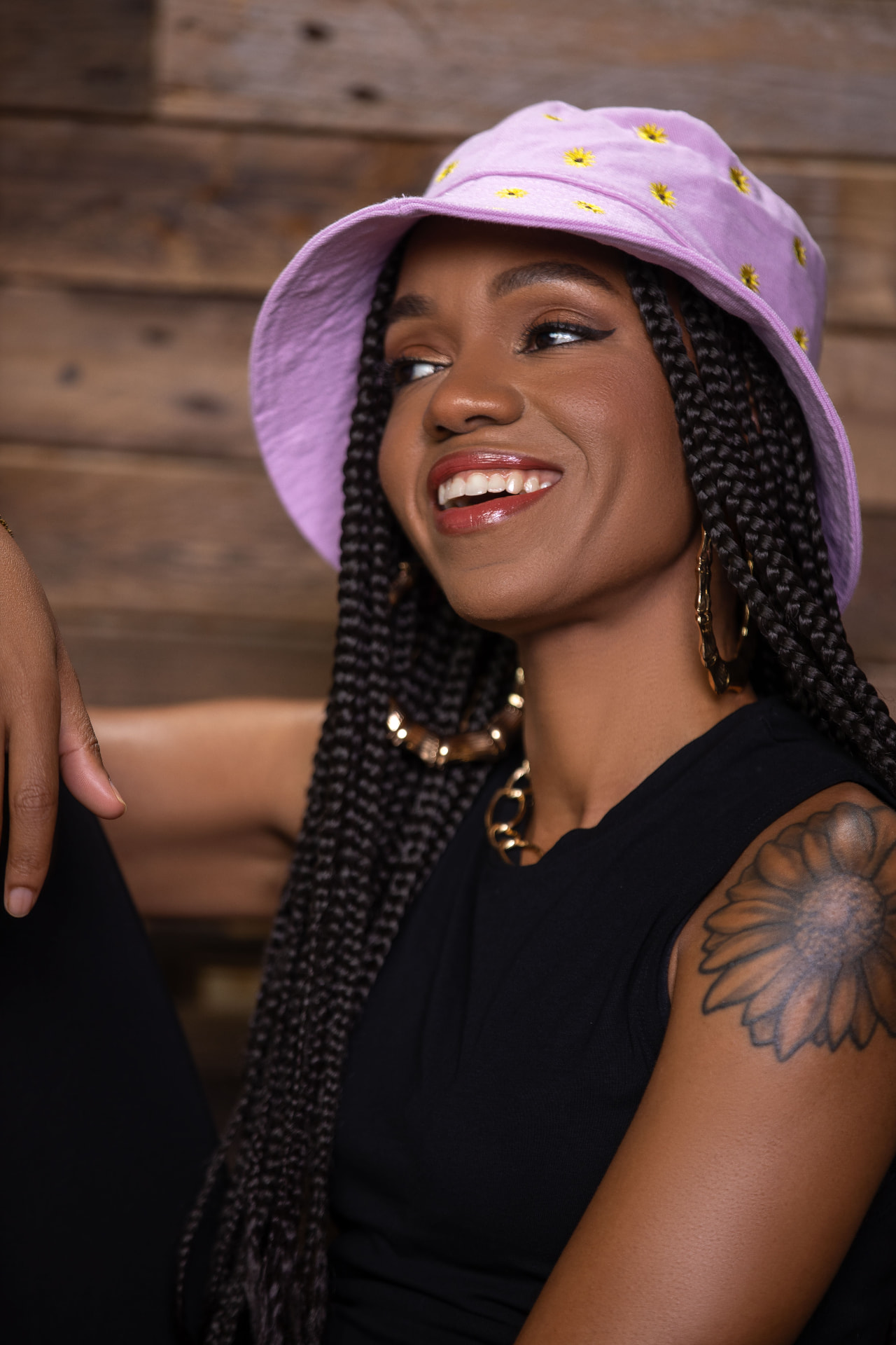 Portrait of Dynasty smiling in a lavender floral bucket hat