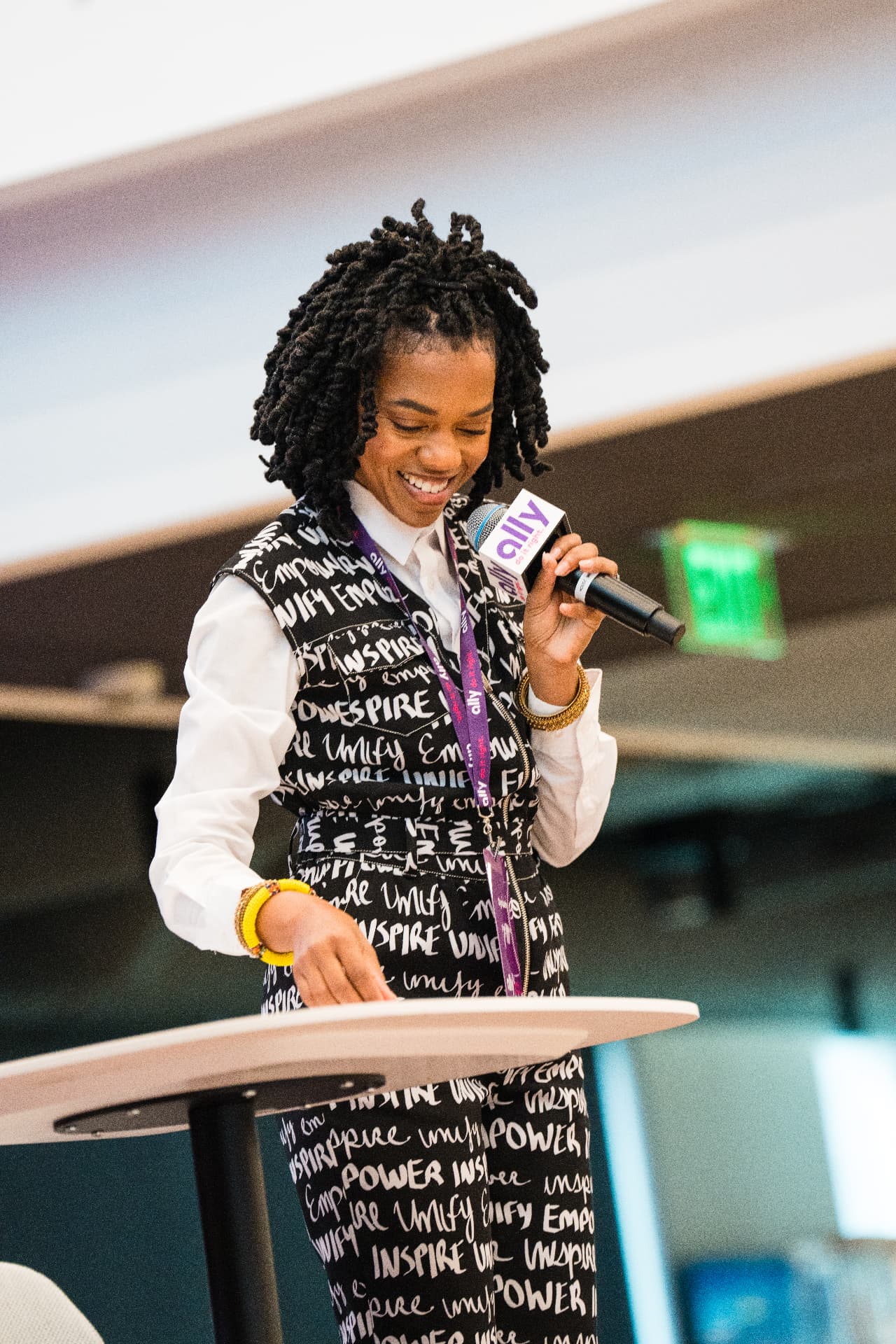 Dynasty presenting at a podium during a speaking engagement