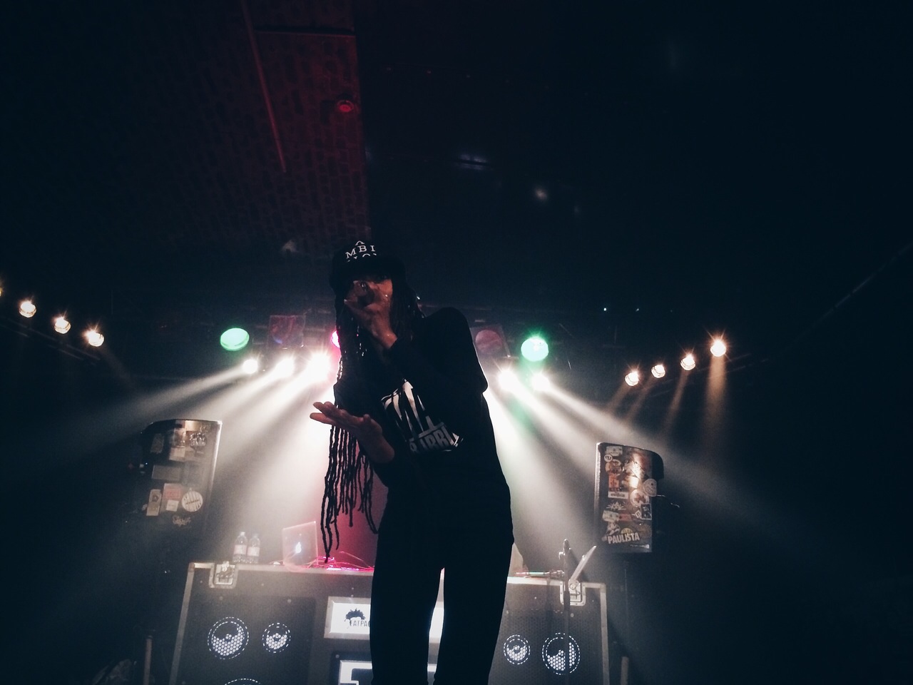 Dynasty performing solo in a club under coloured lights